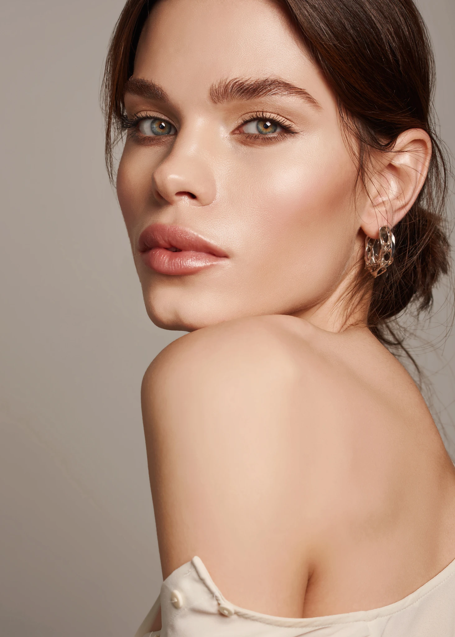 Fashion Portrait Of Beautiful Luxury Woman With Jewelry. Close up of young woman wearing shiny necklace and earrings.