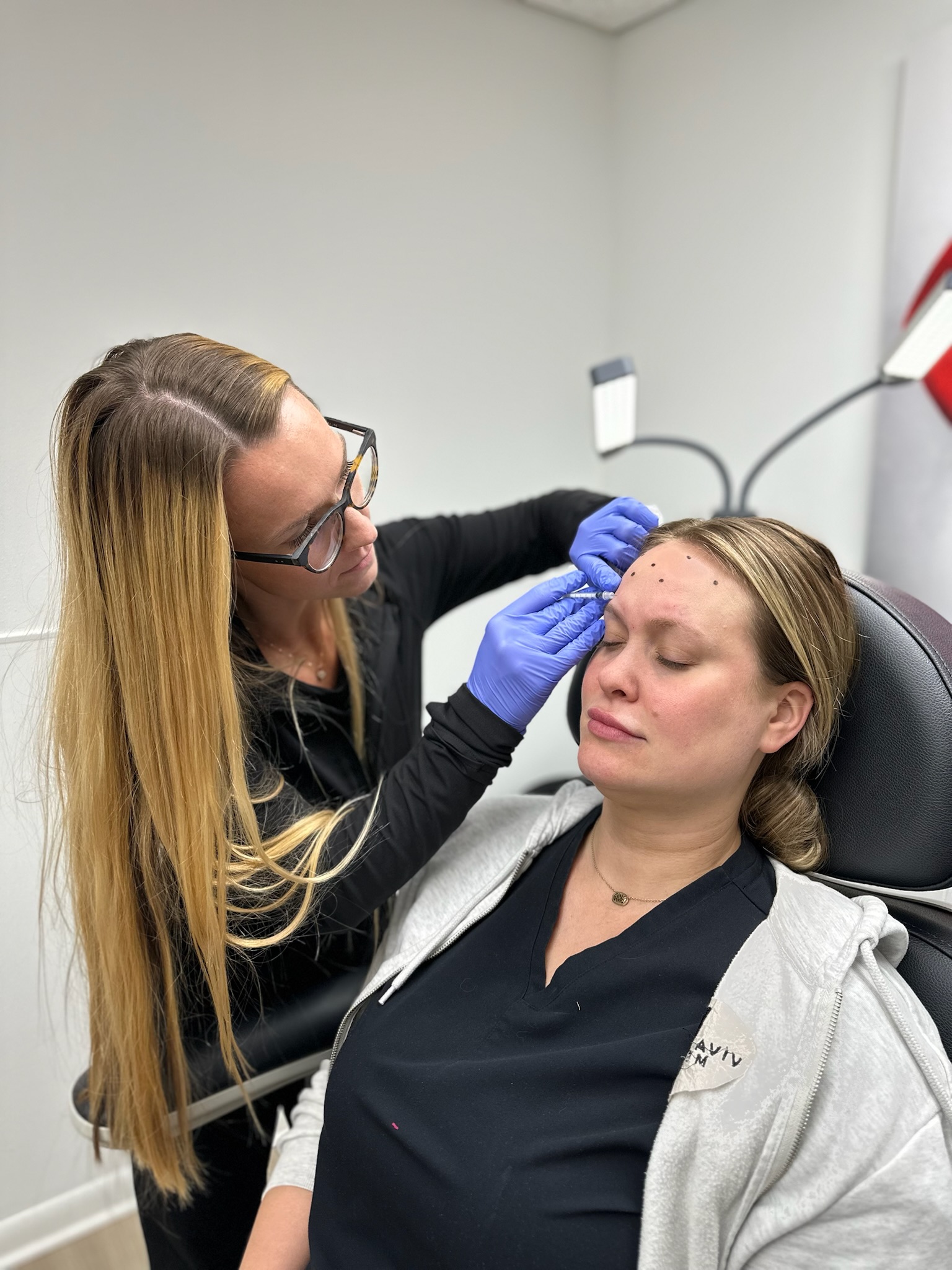 Injector treating the forehead with Botox at Viva Vitality MedSpa in Lakeland, Florida